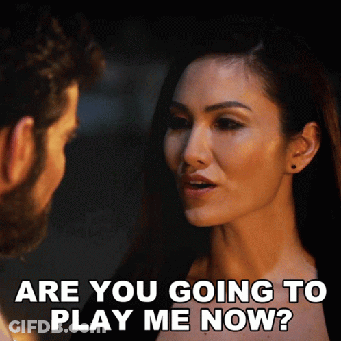A Woman Is Asking A Man If He Is Going To Play Her GIF