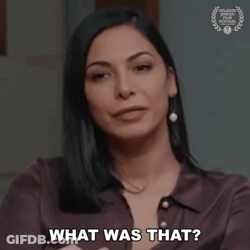 A Woman Is Asking What Was That While Holding Her Hand To Her Chest . GIF