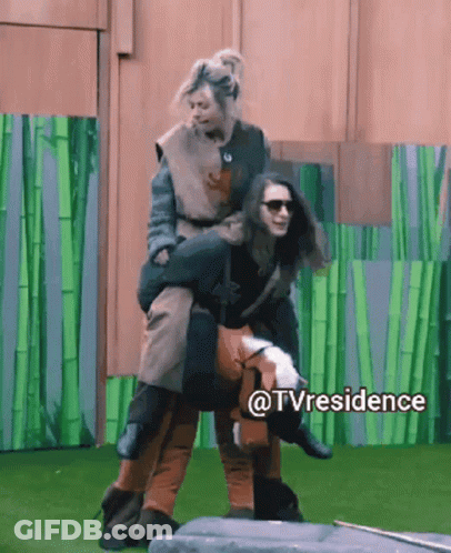 A Woman Is Being Carried On The Back Of Another Woman In A TV Residence Scene GIF