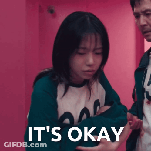 A Woman Is Being Held By A Man With The Words It 'S Okay Written On The Bottom GIF