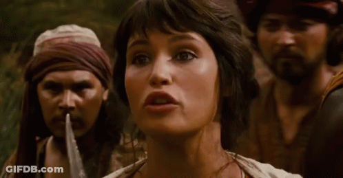 A Woman Is Being Tied Up By A Man With A Rope Around Her Mouth . GIF