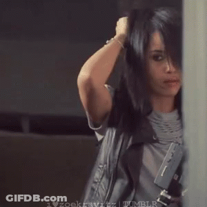 A Woman Is Blow Drying Her Hair While Holding A Hair Dryer In Her Hand . GIF