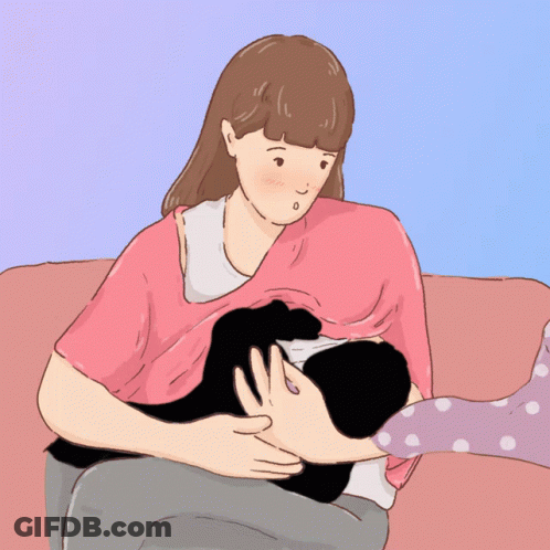 A Woman Is Breastfeeding A Baby On A Couch GIF