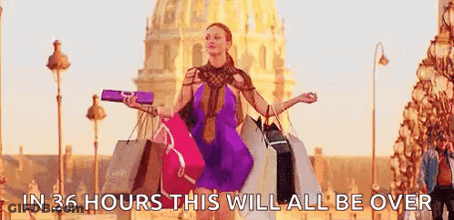 A Woman Is Carrying A Bunch Of Shopping Bags On A Street . GIF