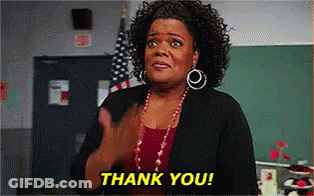 A Woman Is Clapping Her Hands In A Classroom And The Words Thank You Are On The Screen Behind Her . GIF