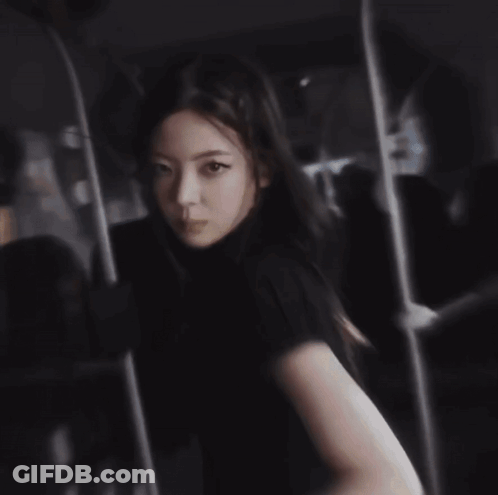 A Woman Is Covering Her Face With Her Hand . GIF