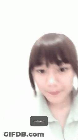A Woman Is Covering Her Face With Her Hand And A Foreign Language Is Displayed In The Corner . GIF