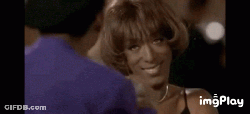 A Woman Is Covering Her Face With Her Hands While A Man Holds Her Hand . GIF
