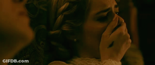 A Woman Is Covering Her Mouth With Her Hand While Another Woman Looks On . GIF