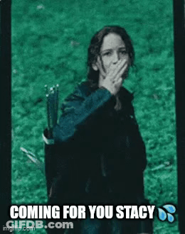 A Woman Is Covering Her Mouth With Her Hand While Holding A Bow And Arrow In A Field . GIF