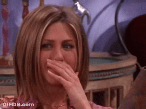 A Woman Is Covering Her Mouth With Her Hand While Laughing GIF