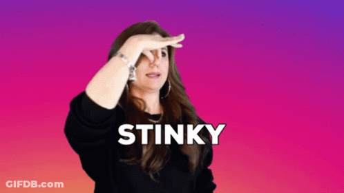 A Woman Is Covering Her Nose With Her Hand And The Word Stinky Is Above Her GIF