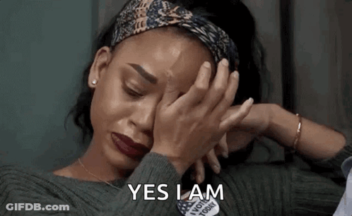 A Woman Is Crying And Covering Her Face With Her Hands And The Words `` Yes I Am '' Written On The Bottom . GIF