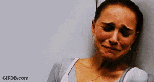 A Woman Is Crying And Leaning Against A Wall With Her Eyes Closed GIF