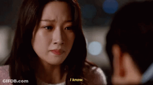 A Woman Is Crying And Talking To Another Woman While A Man Looks On . GIF