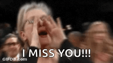 A Woman Is Crying In A Crowd Of People While Holding Her Hands To Her Face . GIF