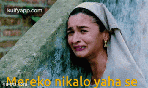 A Woman Is Crying In Front Of A Wall With The Words Mereko Nikalo Yaha Se GIF
