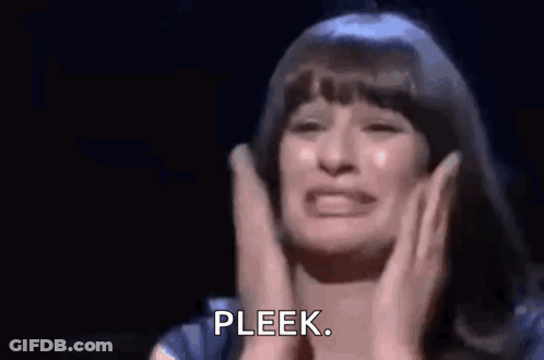 A Woman Is Crying On A Stage While Holding Her Hands To Her Chest . GIF