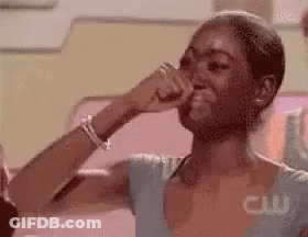 A Woman Is Crying While Covering Her Nose With Her Hand . GIF