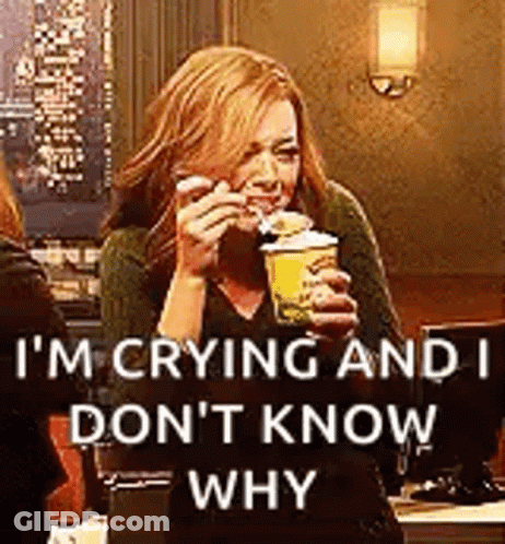 A Woman Is Crying While Holding A Cup Of Coffee And A Sandwich . GIF