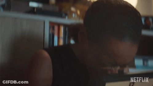 A Woman Is Crying While Holding A Picture Frame With A Netflix Logo On It GIF