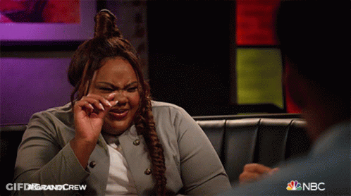 A Woman Is Crying While Sitting On A Couch With Nbc Written On The Bottom GIF