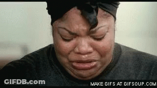 A Woman Is Crying With Her Eyes Closed And Her Headband On . GIF