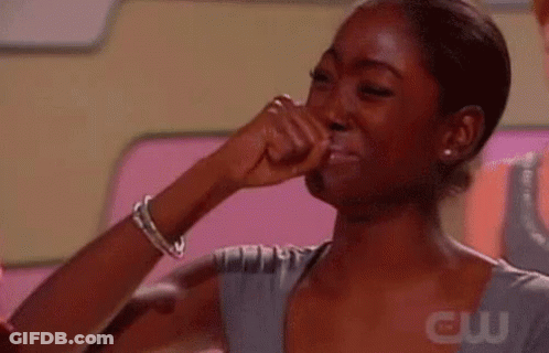 A Woman Is Crying With Her Fist In The Air . GIF