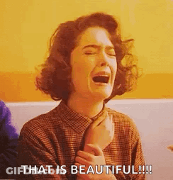 A Woman Is Crying With Her Mouth Open And The Words `` That Is Beautiful '' Written Next To Her . GIF