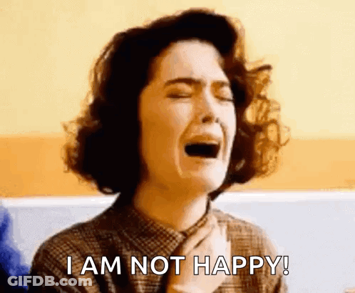A Woman Is Crying With The Words `` I Am Not Happy '' Written Below Her . GIF