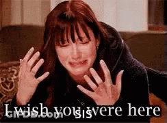 A Woman Is Crying With The Words `` I Wish You Were Here '' Written On The Bottom . GIF