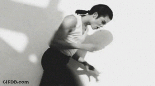 A Woman Is Dancing In A Black And White Photo With Her Arms Outstretched . GIF