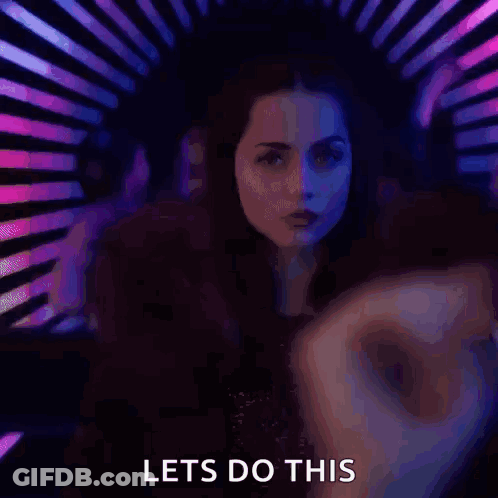 A Woman Is Dancing In A Club With The Words Let 'S Do This Written Below Her . GIF