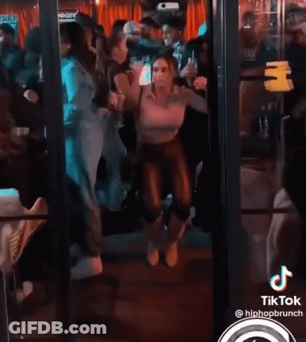 Woman Dancing In Crowd With TikTok Logo GIF