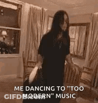 A Woman Is Dancing In A Living Room While Holding A Bag . GIF