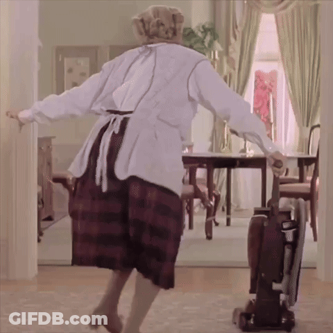 A Woman Is Dancing In A Room With A Vacuum Cleaner GIF