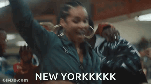 A Woman Is Dancing In A Room With Her Arms In The Air And The Words `` New Yorkkkk '' . GIF