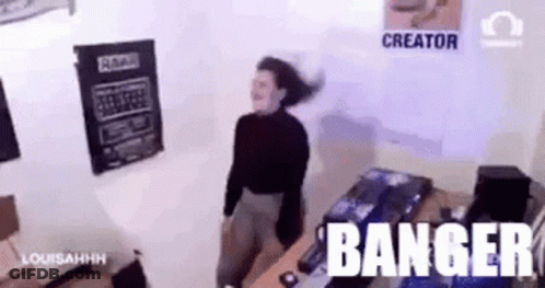 A Woman Is Dancing In A Room With The Words Banger Written On The Wall Behind Her . GIF