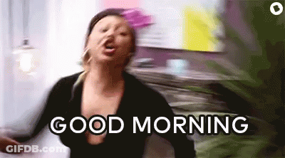 A Woman Is Dancing In A Room With The Words `` Good Morning '' Written On The Screen . GIF
