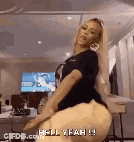 A Woman Is Dancing In A Room With The Words `` Hell Yeah !!! '' Written On The Bottom Of The Image . GIF
