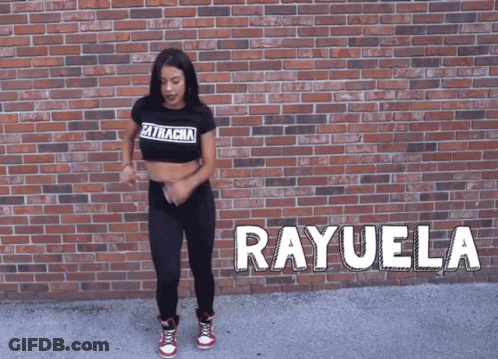 A Woman Is Dancing In Front Of A Brick Wall And The Name Rayuela Is On The Ground GIF
