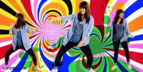 A Woman Is Dancing In Front Of A Colorful Swirl Background GIF
