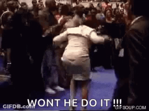 A Woman Is Dancing In Front Of A Crowd With The Words `` Won 'T He Do It '' . GIF