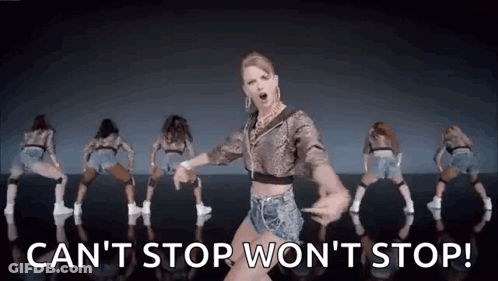 A Woman Is Dancing In Front Of A Group Of Dancers . GIF