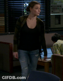 A Woman Is Dancing In Front Of A Laptop In A Room GIF