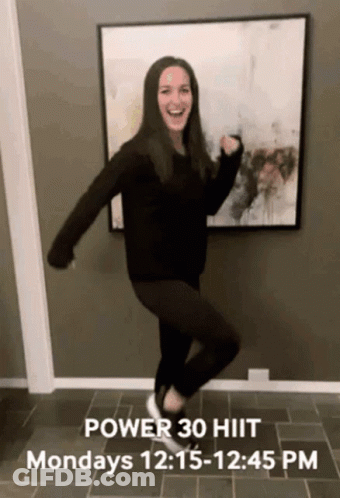 A Woman Is Dancing In Front Of A Picture That Says Power 30 Hiit Mondays 12 : 15-12 : 45 Pm GIF