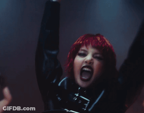 A Woman Is Dancing In Front Of A Screen That Says Futw GIF