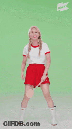 A Woman Is Dancing In Front Of A Sign That Says ' Ithek ' On It GIF