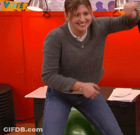 A Woman Is Dancing In Front Of A Sign That Says Vote On It GIF
