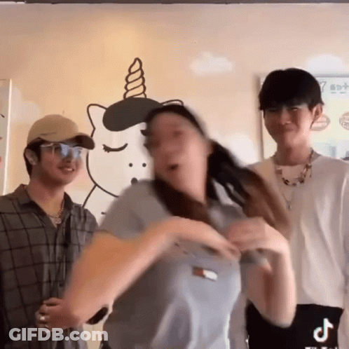 A Woman Is Dancing In Front Of A Wall With A Unicorn Drawing On It GIF
